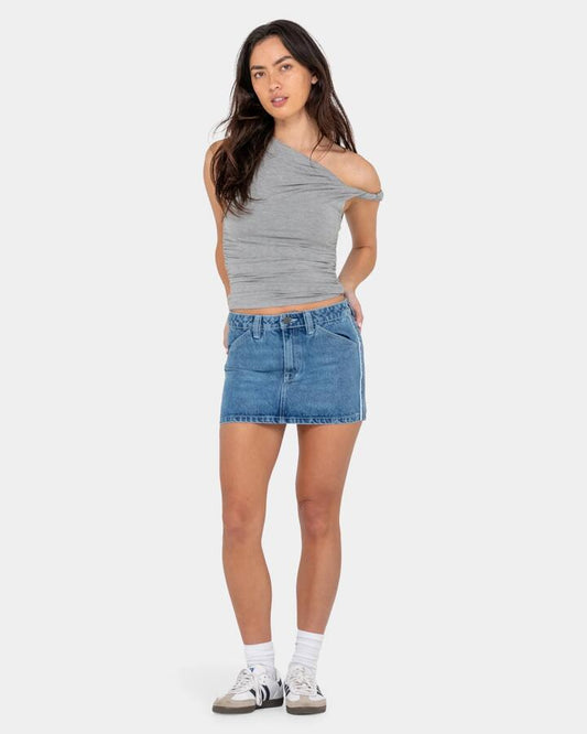 Image of a model wearing Skirts. Product name - Rusty Womens Flip Mommy Low Rise Mini Denim Skirt Blasted Middy Blue / in Blasted Middy Blue / colour by brand - Rusty