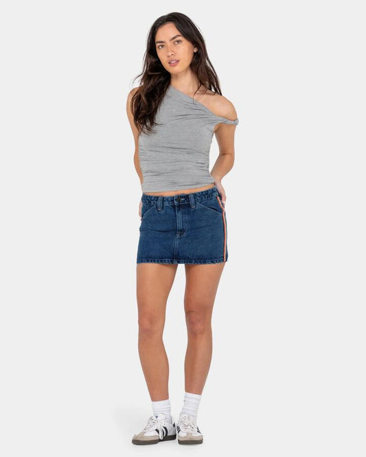 Image of a model wearing Skirts. Productname: Rusty - Womens Flip Mommy Low Rise Mini Denim Skirt - Deep Sea Blue / Oran - in Deep Sea Blue / Oran colour by brand - Rusty