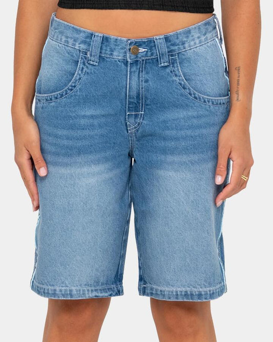 Image of a model wearing Shorts. Product name - Rusty Womens Flip Mommy Low Rise Wide Leg Denim Shorts Blasted Middy Blue / in Blasted Middy Blue / colour by brand - Rusty