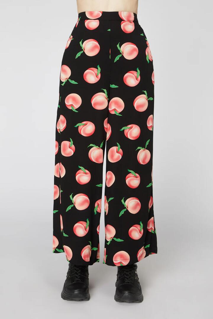 Image of a model wearing Pants. Productname: Peachy Viscose Flare Pant in Black colour by brand - Dangerfield