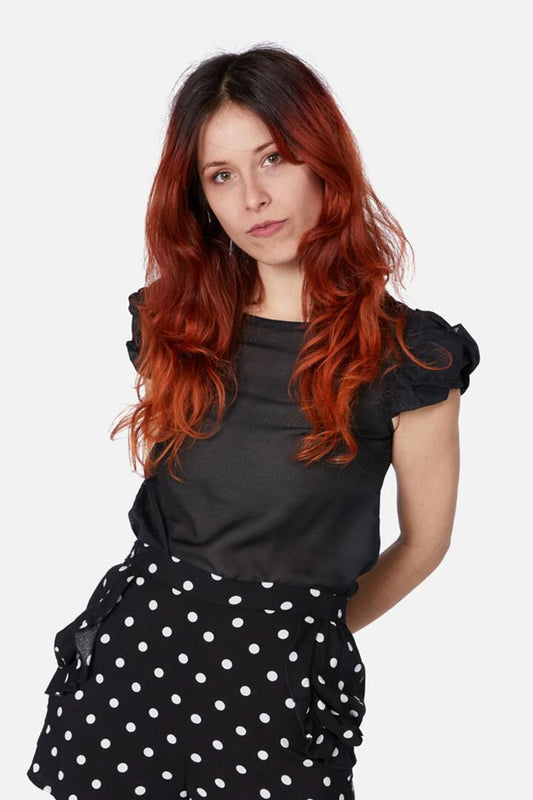 Image of a model wearing Tops. Productname: Twisted Sister Blouse in Black colour by brand - Revival