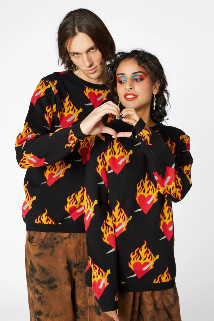 Image of a model wearing Tops. Productname: Flamed Heart Unisex Knit in Black colour by brand - Dangerfield