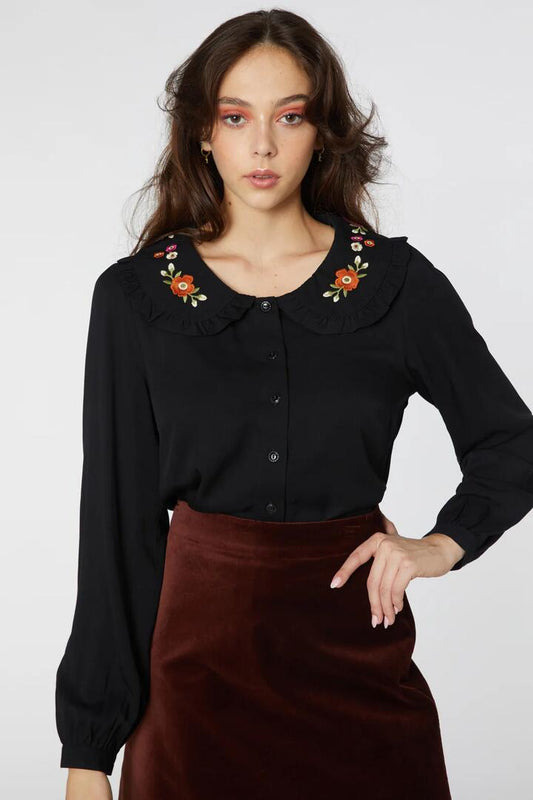 Image of a model wearing Tops. Productname: Ingrid Emb Blouse in Black colour by brand - Princess Highway
