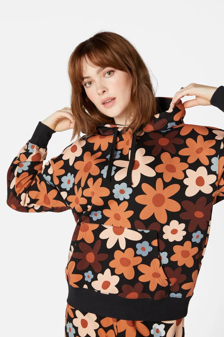 Image of a model wearing Outerwear. Productname: 60SDaisyFloralTrackHoodi in Black colour by brand - Princess Highway