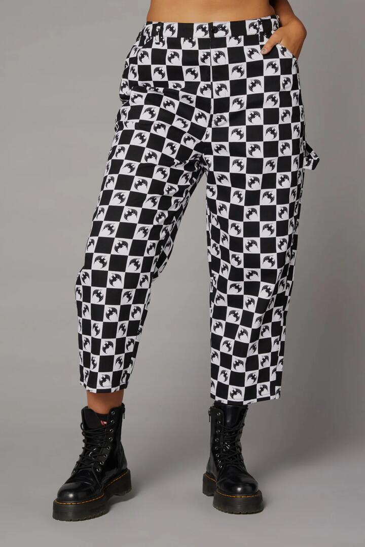 Image of a model wearing Pants. Productname: Bat Check Print GothPant in Black/White colour by brand - Black Friday