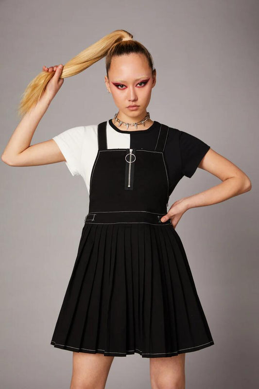 Image of a model wearing Dress. Productname: Goth Pleated Twill Pinny in Black colour by brand - Black Friday