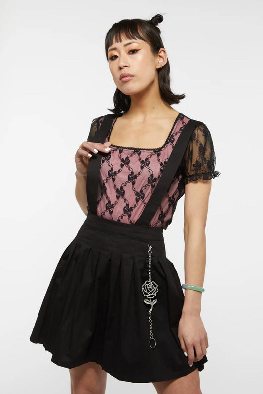 Image of a model wearing Dress. Productname: Last Rose Suspender Pinny in Black colour by brand - Dangerfield