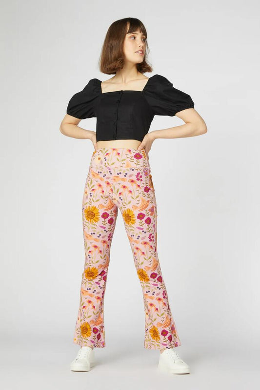 Image of a model wearing Pants. Productname: Wild Garden Flare Pant in Pink colour by brand - Princess Highway