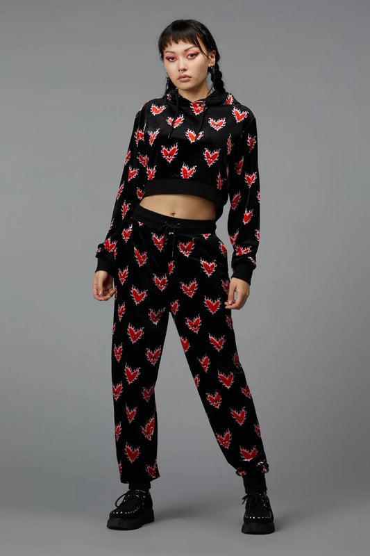 Image of a model wearing Pants. Productname: Flamin Hearts Velour Trackpant in Black colour by brand - Black Friday
