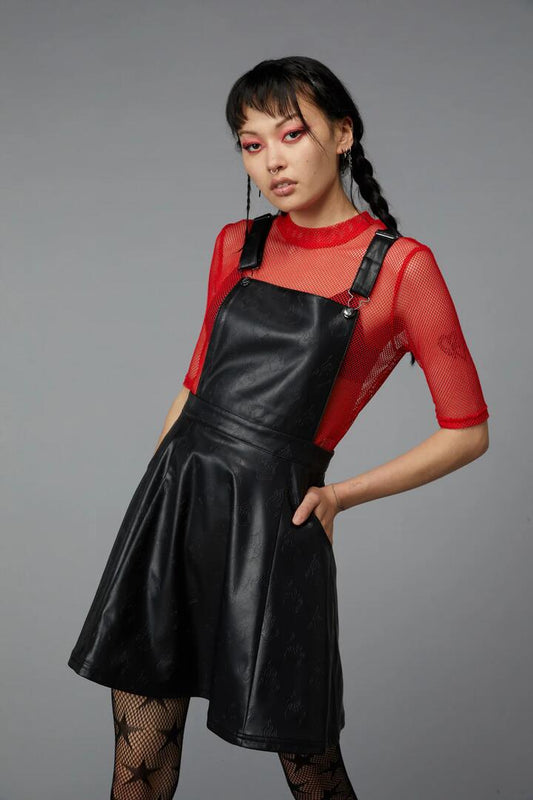 Image of a model wearing Dress. Productname: Flamin Embossed Pu Pinafore in Black colour by brand - Black Friday