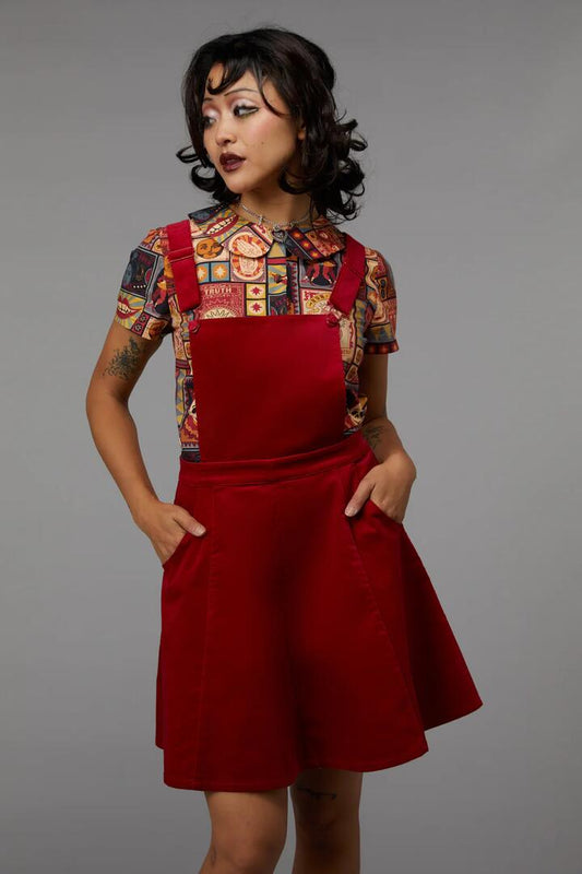 Image of a model wearing Dress. Productname: Ring Mastress Pinafore in Black colour by brand - Black Friday