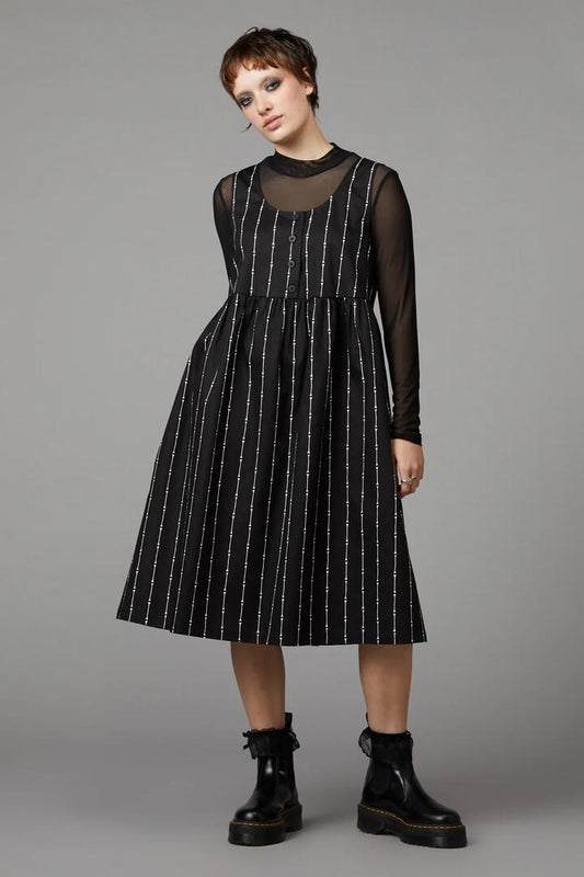 Image of a model wearing Dress. Productname: Funny Bone Pinafore in Black colour by brand - Black Friday