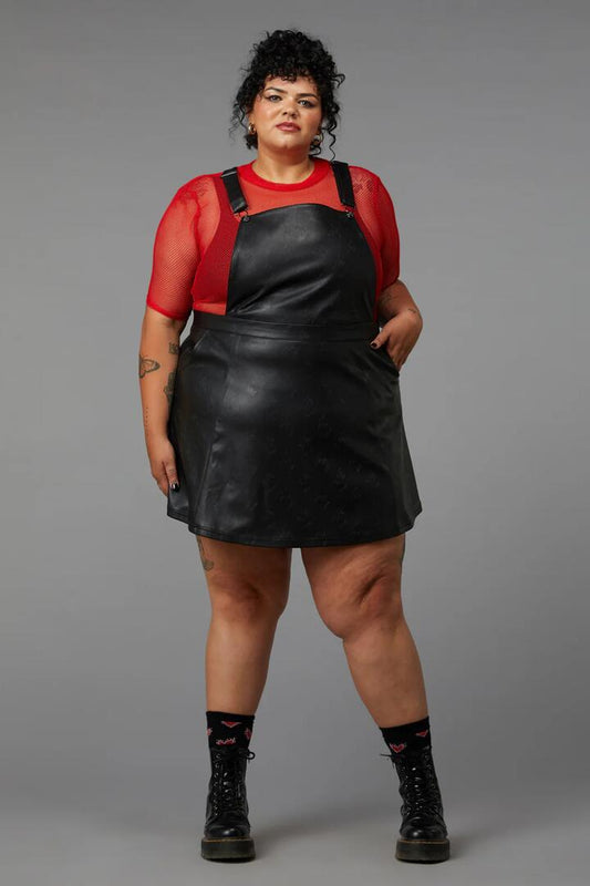 Image of a model wearing Dress. Productname: Curve Flamin Embossed Pu Pinafore in Black colour by brand - Black Friday
