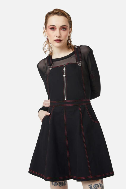 Image of a model wearing Dress. Productname: Defrauded Contrast Stitch Pinafore in Black colour by brand - Dangerfield