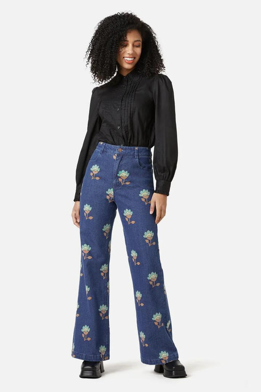Image of a model wearing Denim. Productname: Retro Flora Flare Jean in Dark Denim colour by brand - Princess Highway