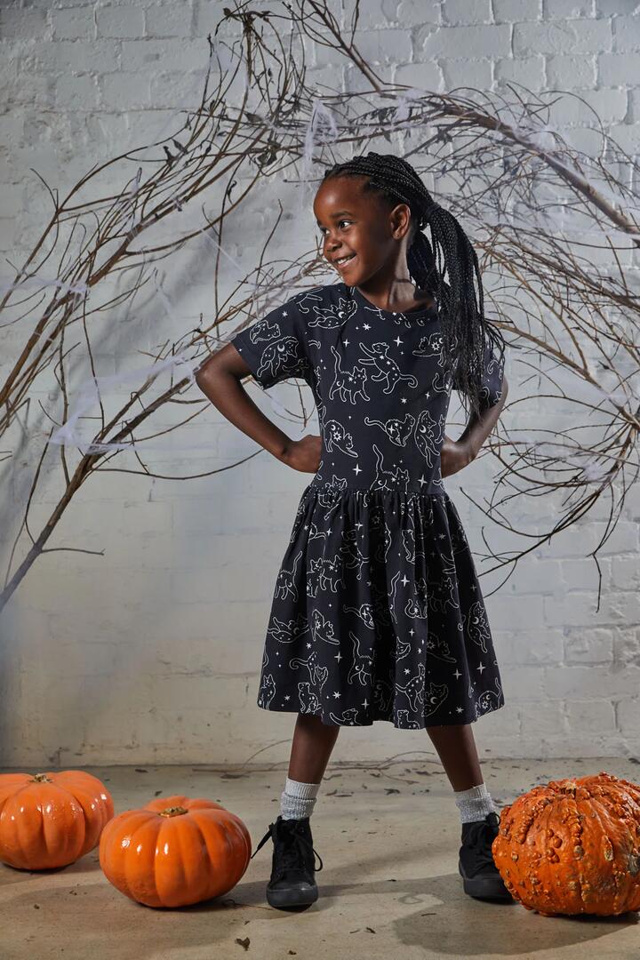 Image of a model wearing Dress. Productname: Celestial Cats Kids Dress in Black colour by brand - Dangerkids