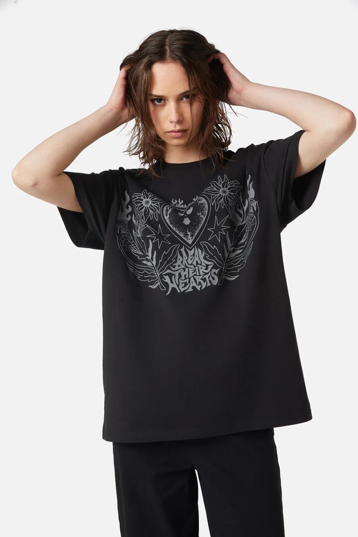 Image of a model wearing Tops. Productname: Break Their Hearts Distressed Tee in Black colour by brand - Dangerfield