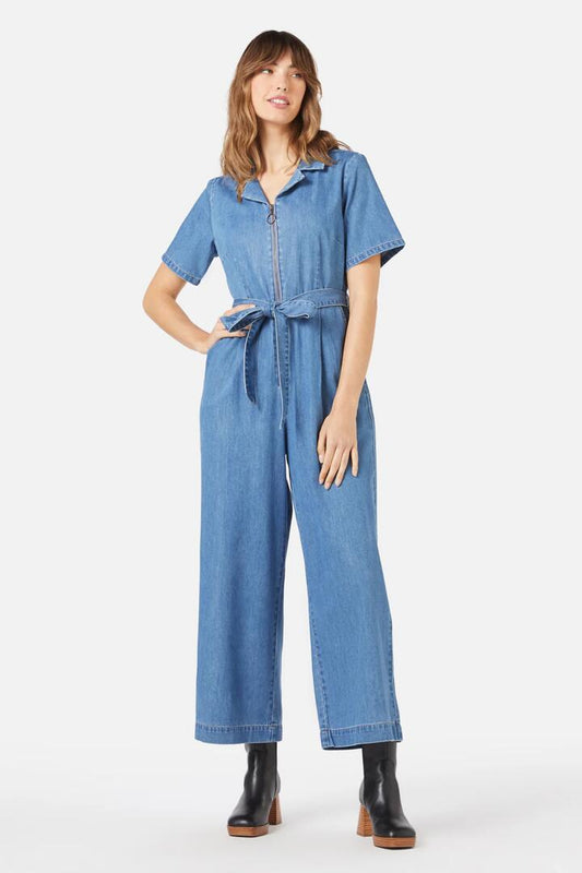 Image of a model wearing Outerwear. Productname: Olympia Jumpsuit in Mid Denim colour by brand - Princess Highway