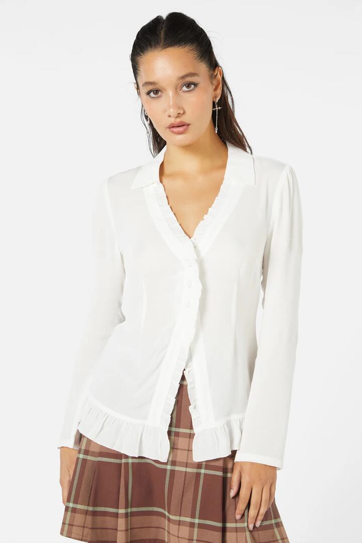 Image of a model wearing Tops. Productname: Fern Frill Blouse in Cream colour by brand - Black Friday