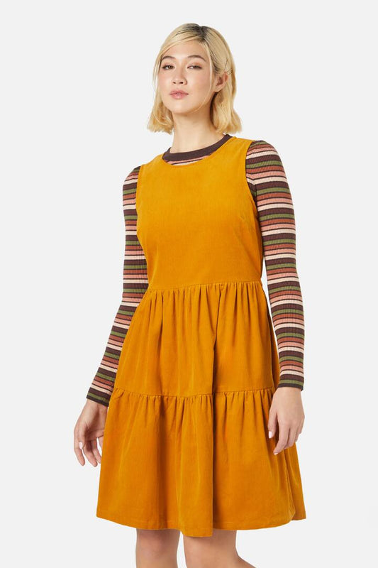 Image of a model wearing Dress. Productname: Dawn Cord Pinny in Mustard colour by brand - Princess Highway