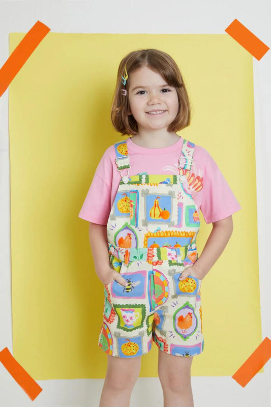 Image of a model wearing Pants. Productname: Cottage Kids Overalls in Cream colour by brand - Princess Highway Kids