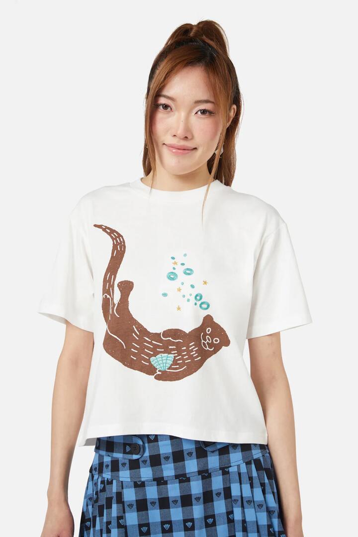 Image of a model wearing Tops. Productname: Otterly Adorable Tee in Cream colour by brand - Dangerfield