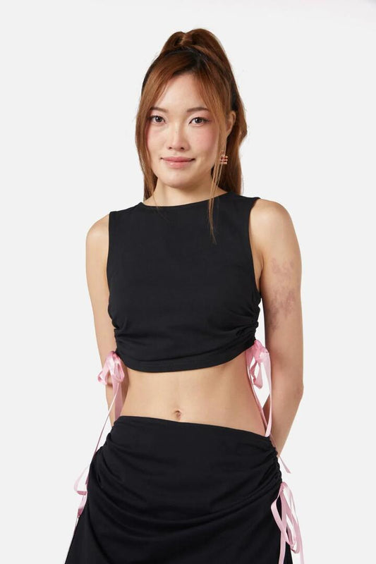 Image of a model wearing Tops. Productname: Milkshake Bow Tank in Black/Pink colour by brand - Dangerfield