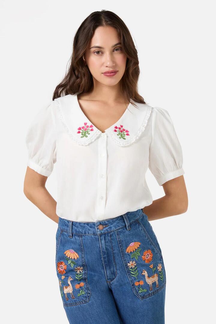Image of a model wearing Tops. Productname: Posie Embroidered Blouse in Cream colour by brand - Princess Highway