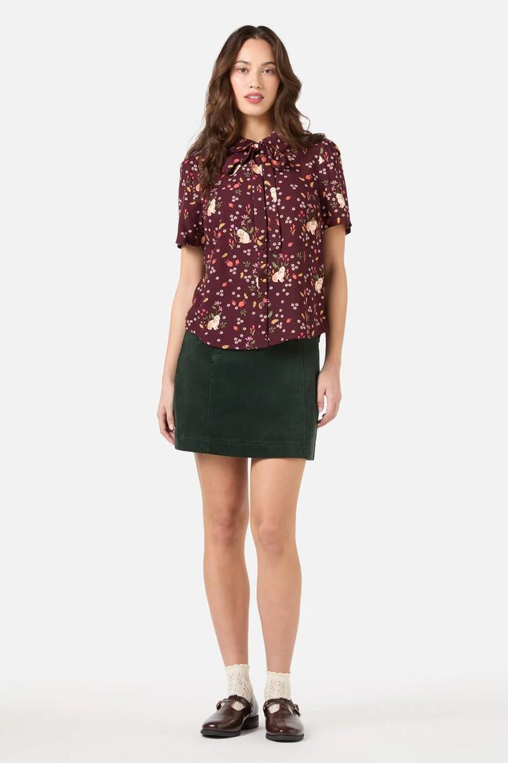 Image of a model wearing Shorts. Productname: Coco Rabbit Short Sleeve Blouse in Burgundy colour by brand - Princess Highway