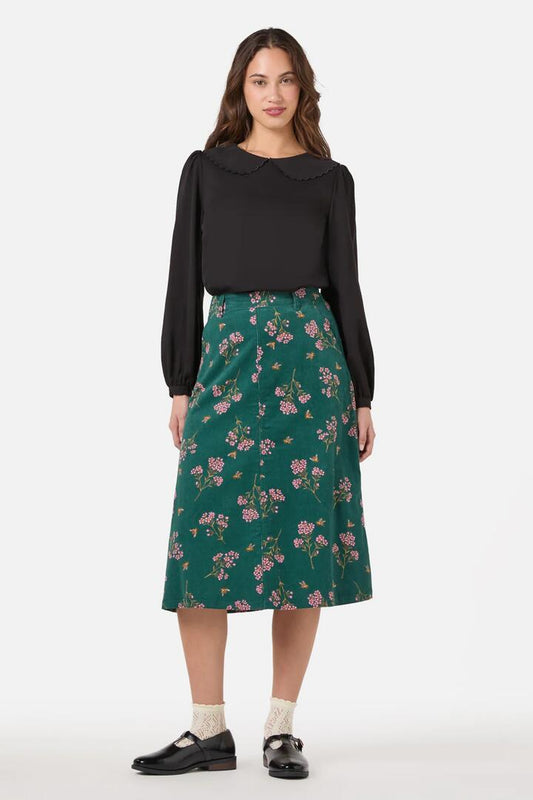 Image of a model wearing Skirts. Productname: Flora Bee Cord Midi Skirt in Green colour by brand - Princess Highway