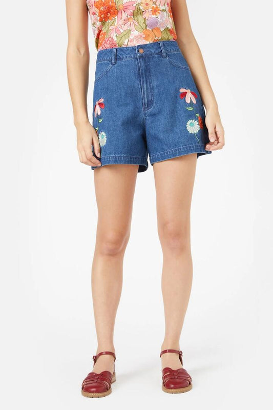 Image of a model wearing Shorts. Product name - Eden Embroidered Short in Mid Denim colour by brand - Princess Highway