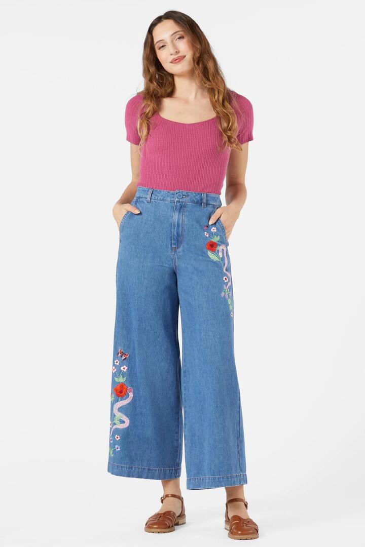 Image of a model wearing Denim. Productname: Snake Embroidered Jean in Blue Denim colour by brand - Princess Highway