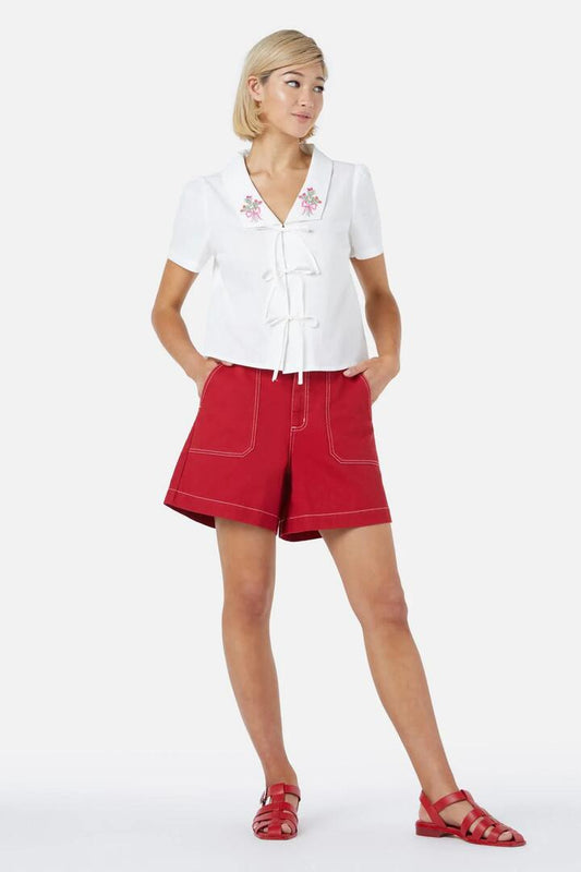 Image of a model wearing Shorts. Productname: Dara Drill Short in Red colour by brand - Princess Highway