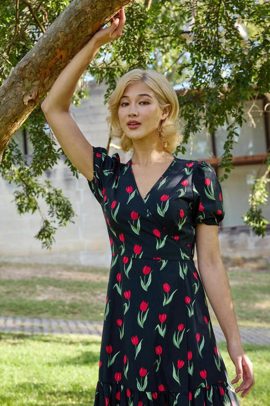Image of a model wearing Dress. Productname: Tulip Midi Wrap Dress in Black colour by brand - Princess Highway