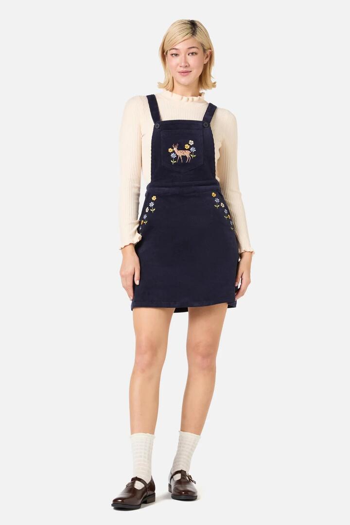 Image of a model wearing Dress. Productname: Deer Embroidered Cord Pinny in Navy colour by brand - Princess Highway