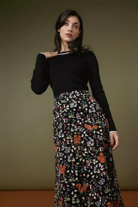 Image of a model wearing Skirts. Productname: Squirrel Away Cord Midi Skirt in Black colour by brand - Princess Highway