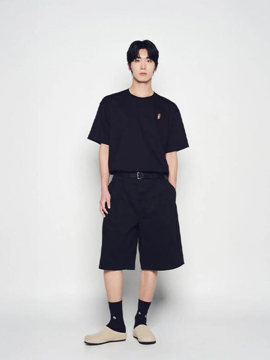 Image of a model wearing Shorts. Productname: ADLV Stand Ac Bear Short Sleeve T-Shirt in Black colour by brand - ADLV