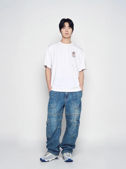 Image of a model wearing Shorts. Productname: ADLV Tanning Opanchu Basic Logo Short Sleeve T-Shirt in White colour by brand - ADLV