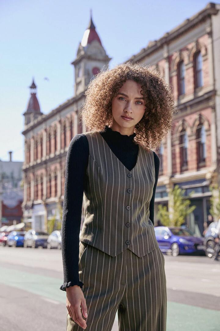 Image of a model wearing Tops. Productname: Abby Pinstripe V-Neck Vest in Olive colour by brand - Princess Highway