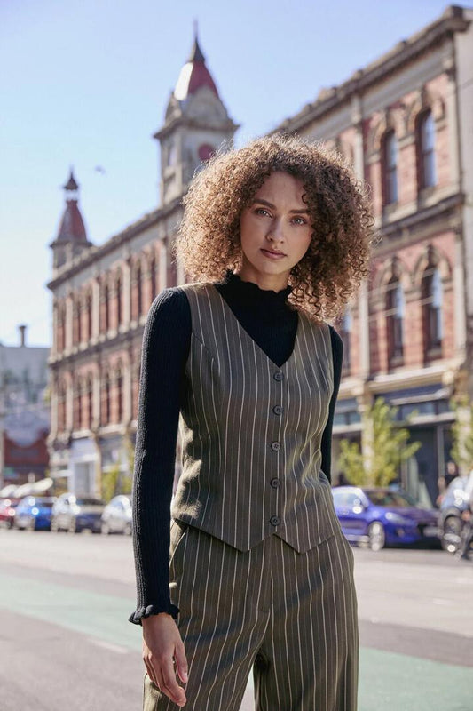 Image of a model wearing Tops. Productname: Abby Pinstripe V-Neck Vest in Olive colour by brand - Princess Highway