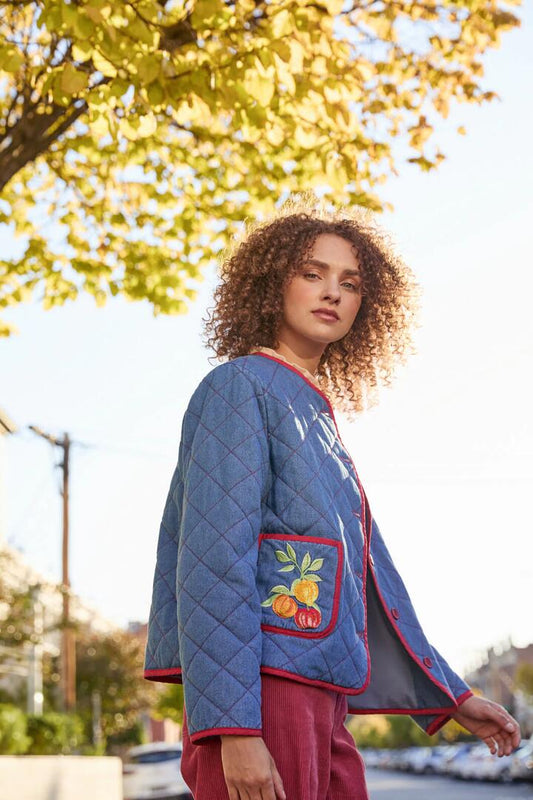 Image of a model wearing Outerwear. Productname: Fruit Emb Quilted Jacket in Blue Denim colour by brand - Princess Highway