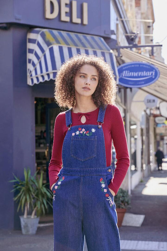 Image of a model wearing Pants. Productname: Flower Bow Embroidered Overall in Blue Denim colour by brand - Princess Highway
