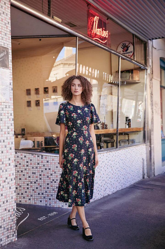 Image of a model wearing Dress. Productname: Lucia Floral Bow Dress in Black colour by brand - Princess Highway