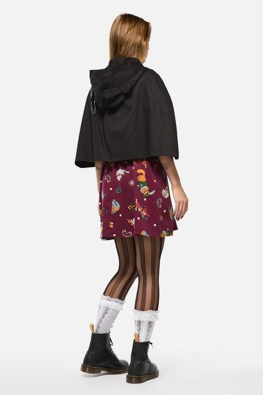 Image of a model wearing Outerwear. Productname: Iykyk Kitty Cape in Black colour by brand - Black Friday