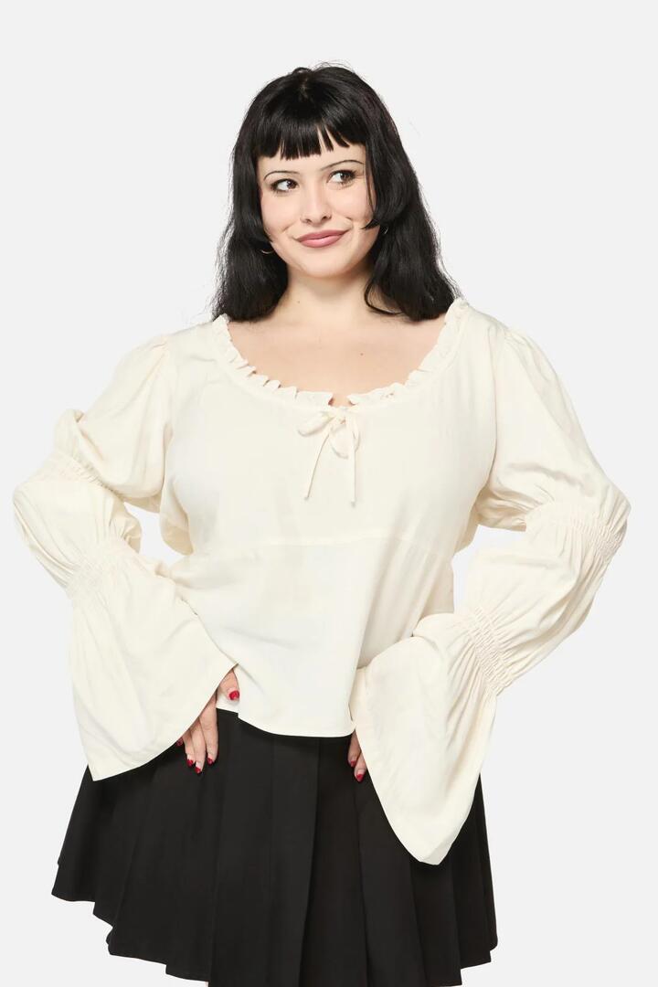 Image of a model wearing Tops. Productname: Curve Puppet Show LS Top in Cream colour by brand - Black Friday