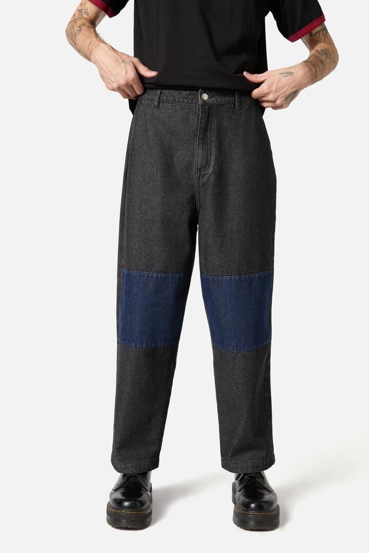 Image of a model wearing Denim. Productname: Iykyk Knee Patch Jeans in Black colour by brand - Black Friday
