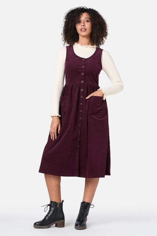 Image of a model wearing Dress. Productname: Demi Cord Pinafore Dress in Plum colour by brand - Princess Highway