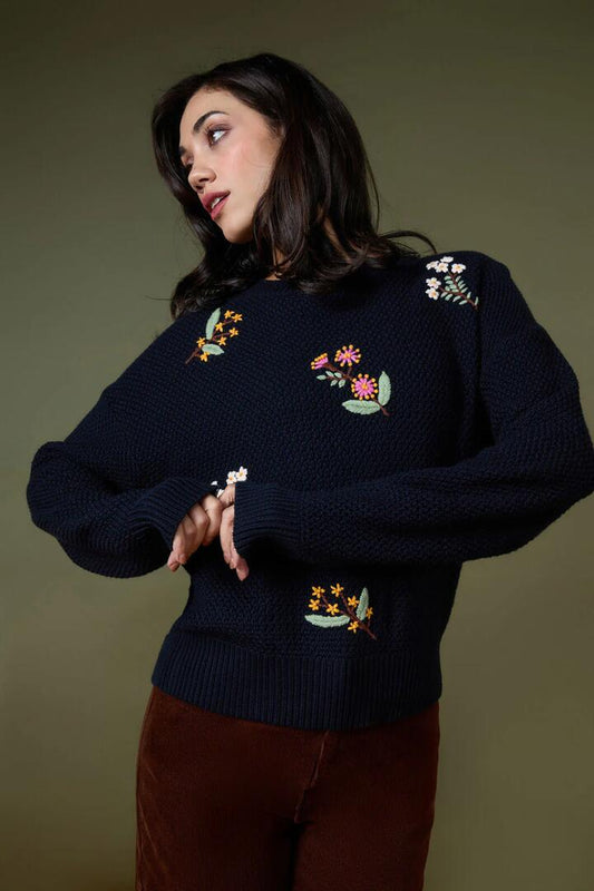 Image of a model wearing Outerwear. Productname: Elsie Embroidered Jumper in Navy colour by brand - Princess Highway