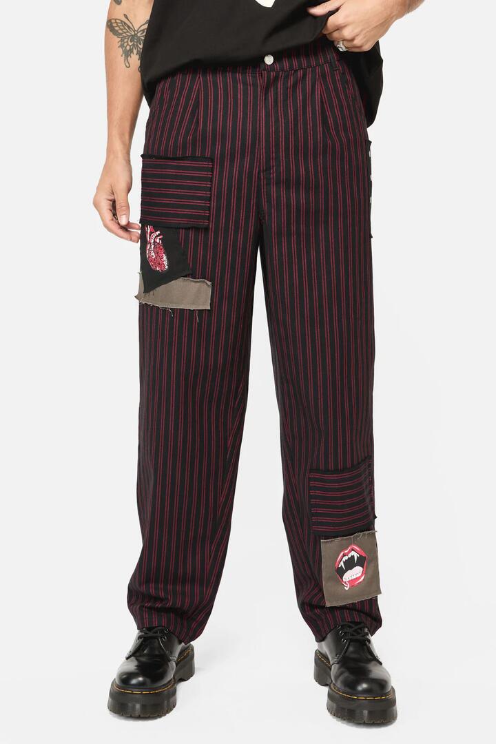 Image of a model wearing Pants. Productname: Undead Pin Stripe Patch Pants in Black/Red colour by brand - Black Friday
