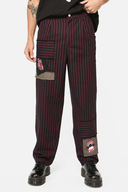 Image of a model wearing Pants. Productname: Undead Pin Stripe Patch Pants in Black/Red colour by brand - Black Friday